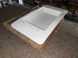 a white bath tub sitting on a pallet in a warehouse