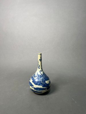 an old blue and white vase with a wave design on it