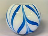 a blue and white striped vase on a white table