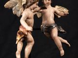 an image of a statue of two angels fighting each other