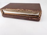 an old book with a piece of paper sticking out of it ' s cover