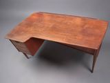 an old wooden desk with a small drawer on top of it