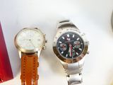 two watches sitting next to each other on a table