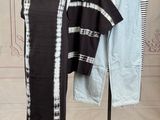 a black and white dress on a stand next to a pair of jeans
