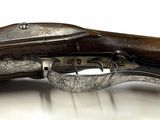 two old guns that are sitting on top of a table