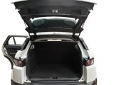 the back of a white car with its trunk open on a white background