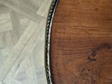 a close up of a tennis racket on a wooden table