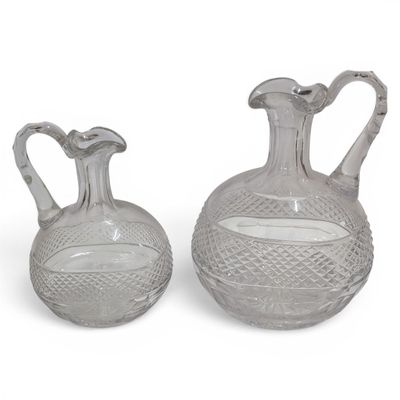 pair of clear glass vases on a white surface with a white background