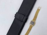 an image of a watch and a black case on a white table