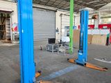 two blue lifts in the middle of a building
