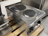a stainless steel stove top with two burners on a pallet