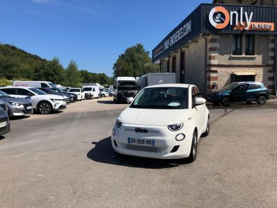 a small white car parked in front of a building
