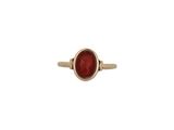 a gold ring with a red stone in the center