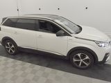 a picture of a white suv parked in a garage