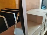 a computer monitor sitting on top of a desk in a room