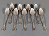 six spoons are lined up in a row on a table