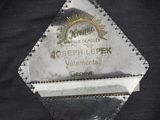 a close up of a black jacket with a label on it