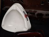 a white urinal sitting on the floor next to a brown bowl