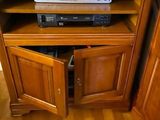 a television sitting on top of a wooden cabinet