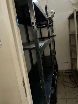 a small room with a shelf and shelves in it