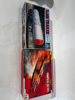 two boxes of toys on a white surface next to each other