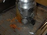 un récipient en métal posé sur une grille métallique