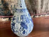 a blue and white vase sitting on a wooden table