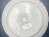 a white plate with a red sticker on it