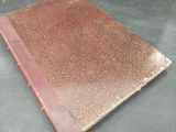 an old book on a table with a black background