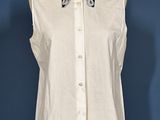 an image of a white shirt with a bow tie on a mannequin