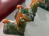 a glass table topped with ceramic figurines of animals