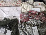 a lot of clothes that are sitting on a table