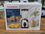 packaging of a blender sitting on top of a wooden table
