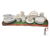 a picture of a set of white dishes and cups on a tray