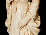 a statue of a woman with a hat and a robe