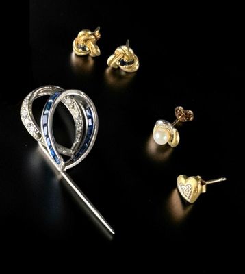 several different types of jewelry are displayed on a black surface