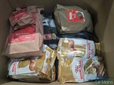 many bags of food in a box on the floor
