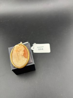 a gold plated ring with an image of a woman on it