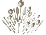 a lot of silver spoons and silverware on a white surface