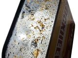 a metal container with rust on it on a white background