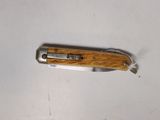a small knife that is laying on a table