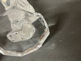a glass figurine of a horse on a table