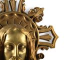 a gold statue of jesus with a cross on it