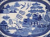 a blue and white plate with a picture on it