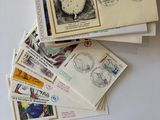 a pile of stamps on top of a white envelope