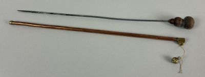 two different types of knitting needles on a white surface