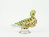 a glass bird that is sitting on top of a glass stand