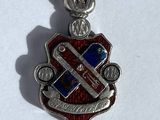 a close up of a metal charm with a flag on it