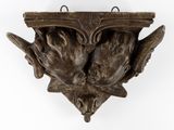 a wall mounted sculpture of two birds on it ' s head