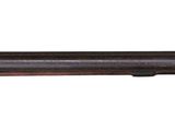 a shotgun with a wooden barrel on a white background
